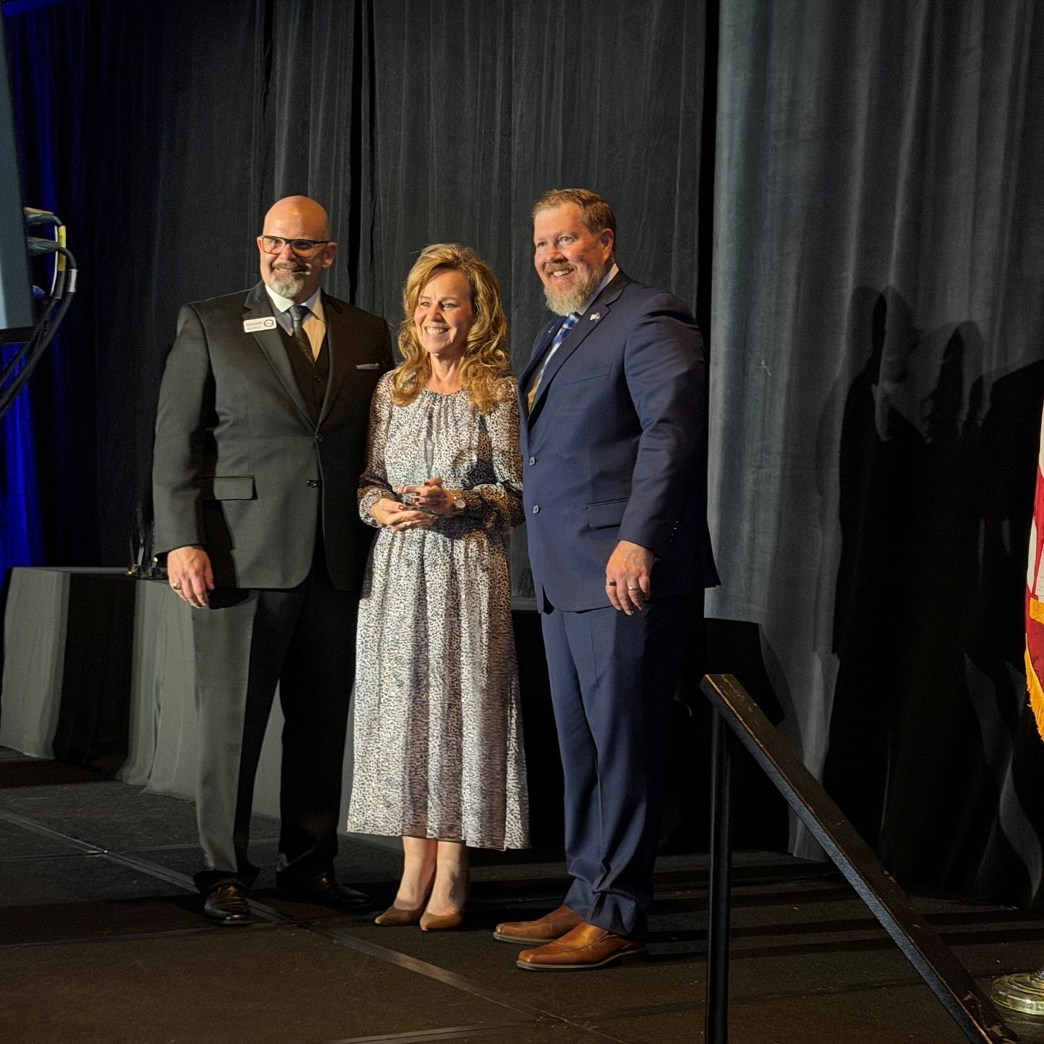 Scott Jensen, National Veteran Small Business Coalition Executive (NVSBC) Director; Tanner; and Robert Better, NVSBC Board President, during the fourth annual Veteran Small Business Advocate Awards Gala. Tanner accepted the award on behalf of SRNS.