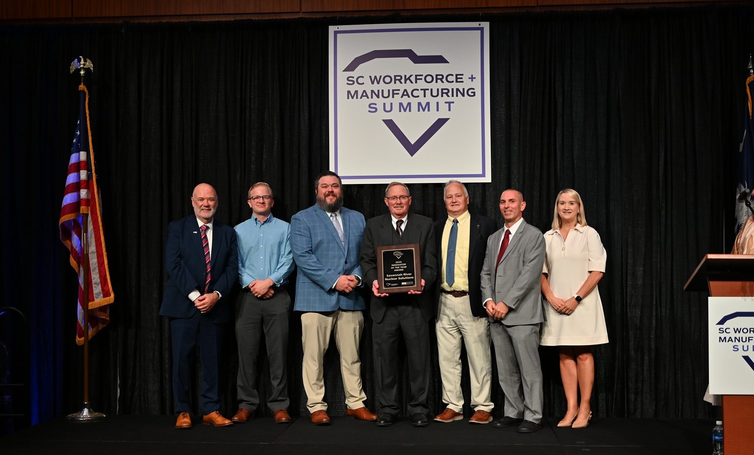 Members from the SRNS Supply Chain Management (SCM) Center of Excellence (COE) team accept the 2026 Innovator of the Year award at the SC Workforce Manufacturing Summit. Pictured from left: Andy Carr, SC Manufacturing Extension President and Chief Executive Officer (CEO); Phoenix Dunn, SRNS Site Services COE Member; Kyle Hayes, SCM Senior Manager; Fred Freeman, Senior Director, SCM Planning and Execution; John Reeder, Senior Manager, SCM Planning and Execution; Ryan Shoaf, Manager, SCM Planning and Execution; and Sara Hazzard, SC Manufacturers and Commerce President and CEO.